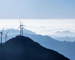 wind turbines and the sea of clouds on stretches of blue mountains background,a panoramic view of the beautiful natural scenery